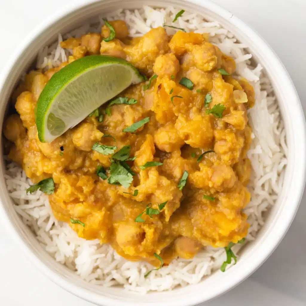 Vegan pumpkin curry in white bowl with rice.