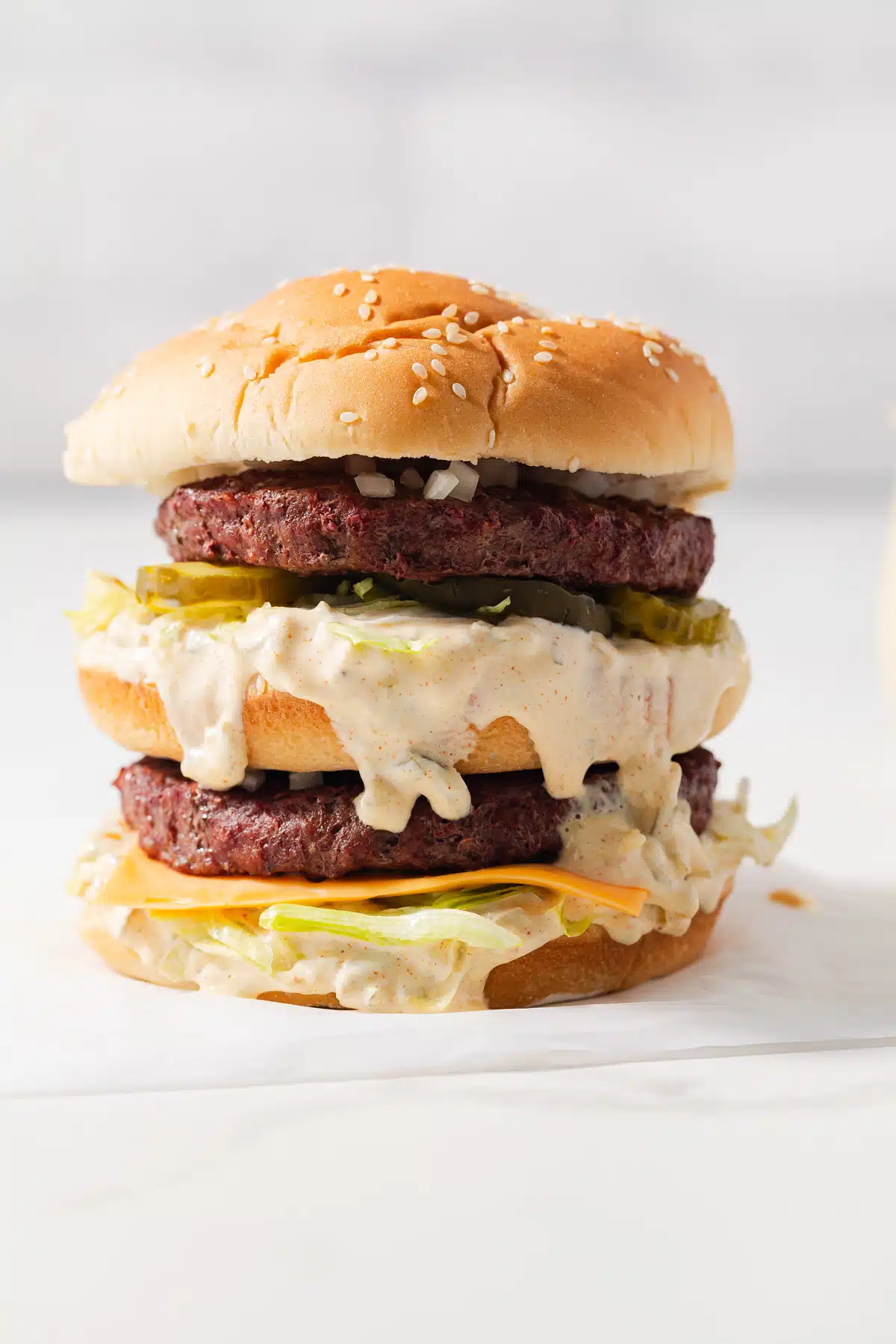 Homemade big mac on parchment paper.