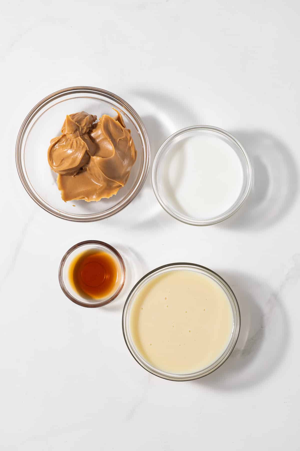 Ingredients for peanut butter dessert sauce in glass bowls.