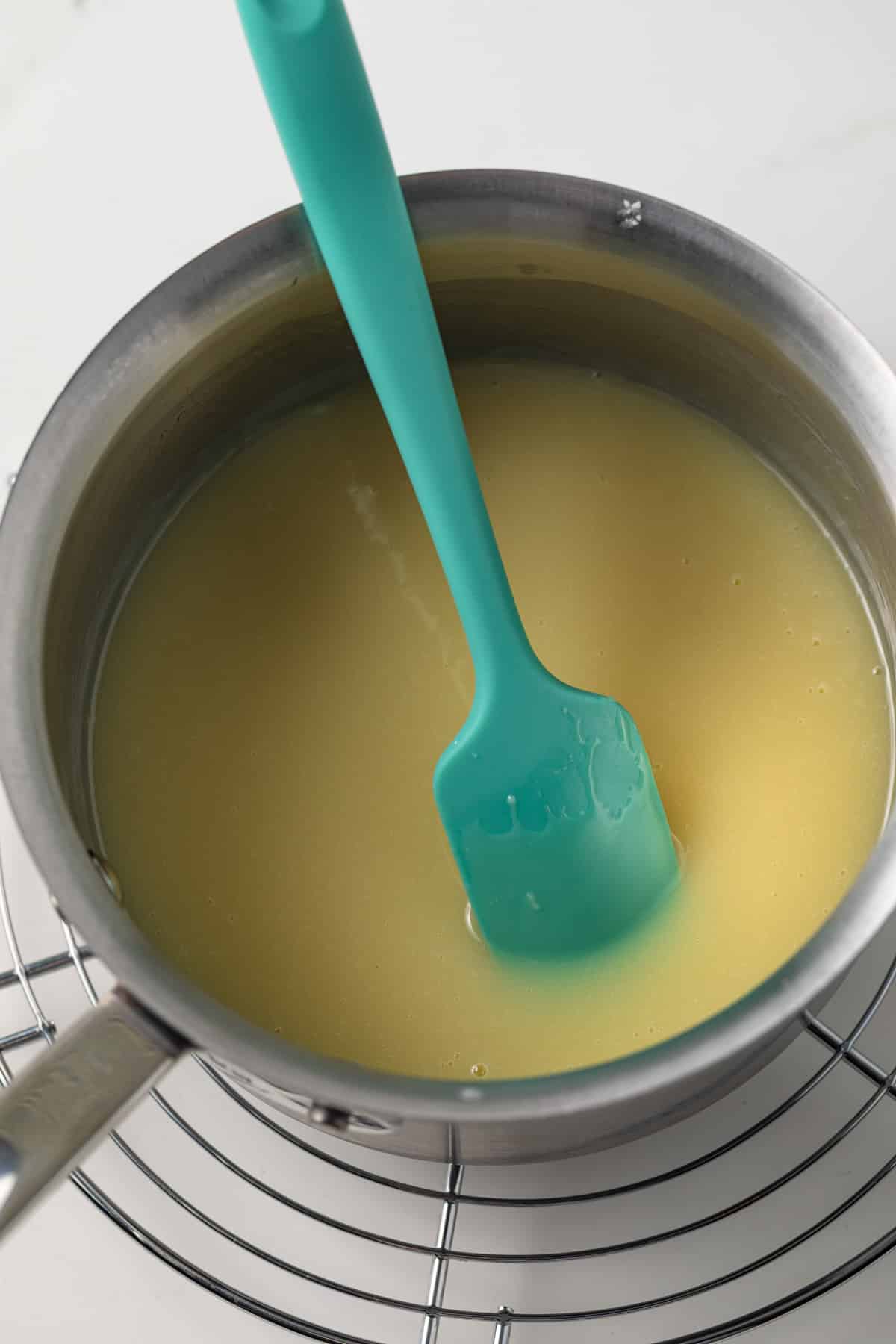 Saucepan with white chocolate sauce.