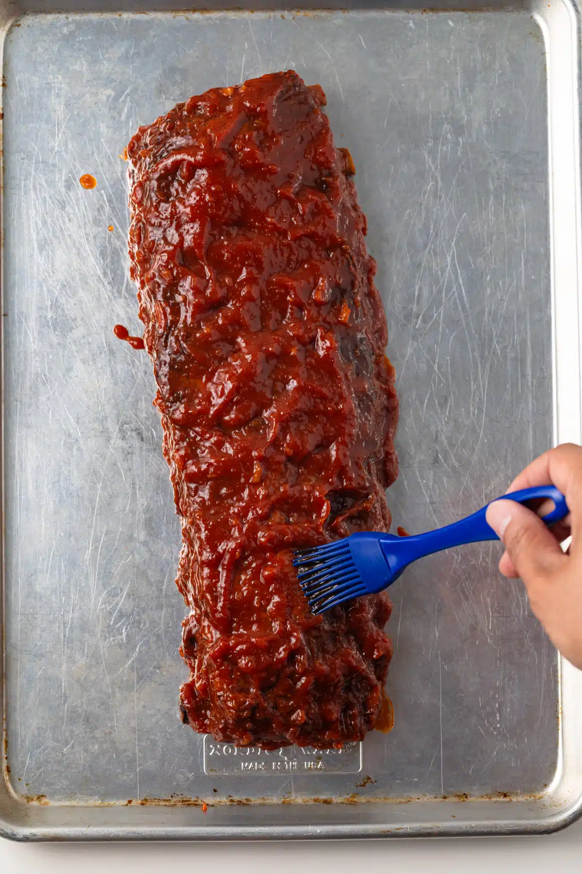 Bbq sauce brushed over ribs.