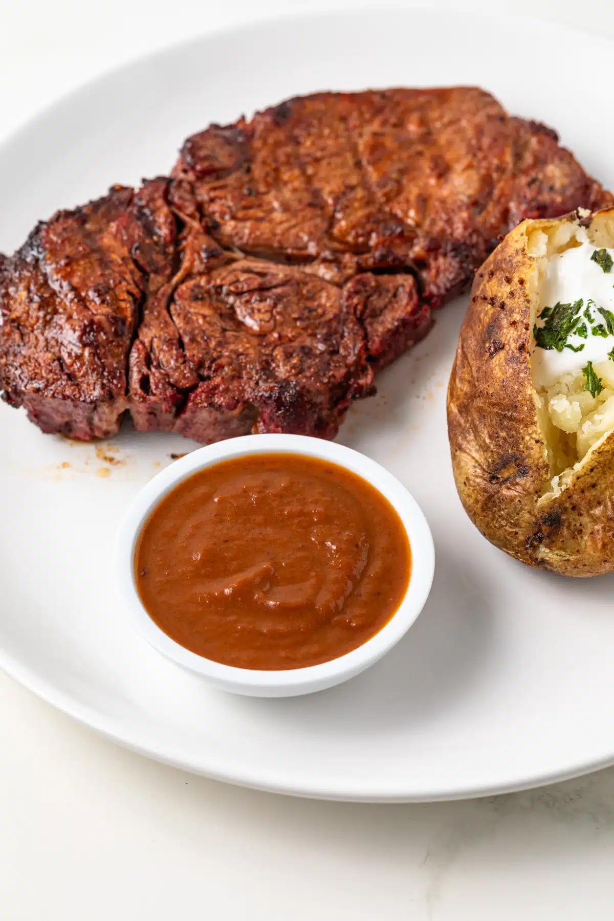 Steak sauce in a white ramekin.