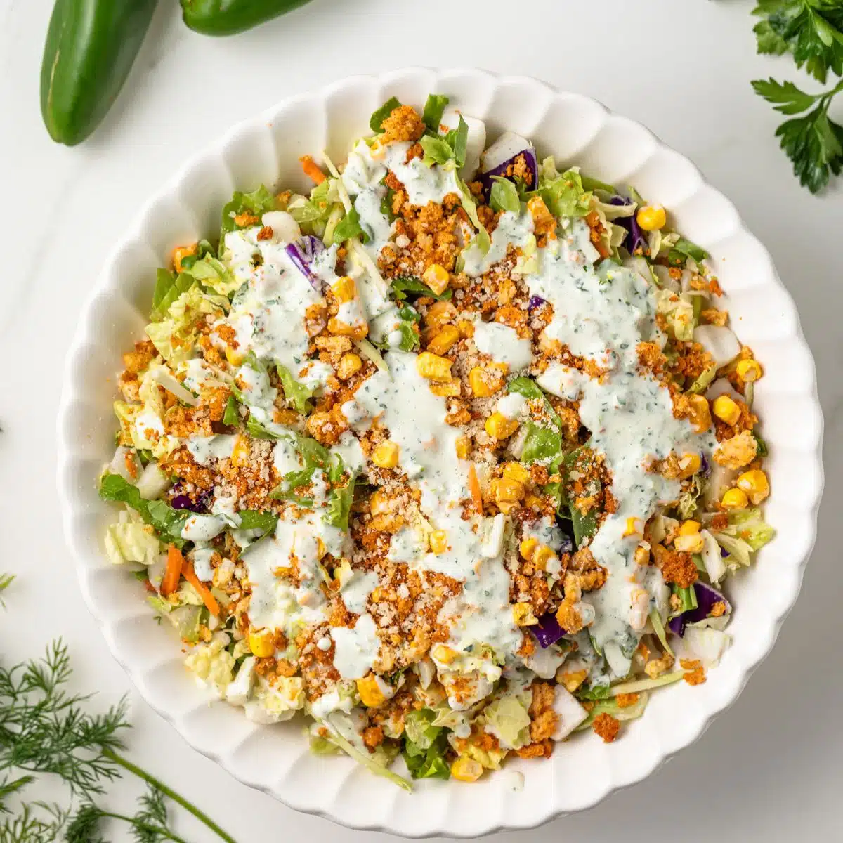 Salad with jalapeno ranch dressing in a bowl.