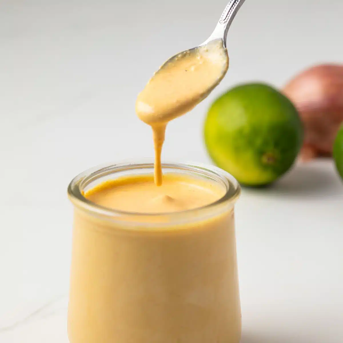 Aji Amarillo Sauce dripping off a spoon.