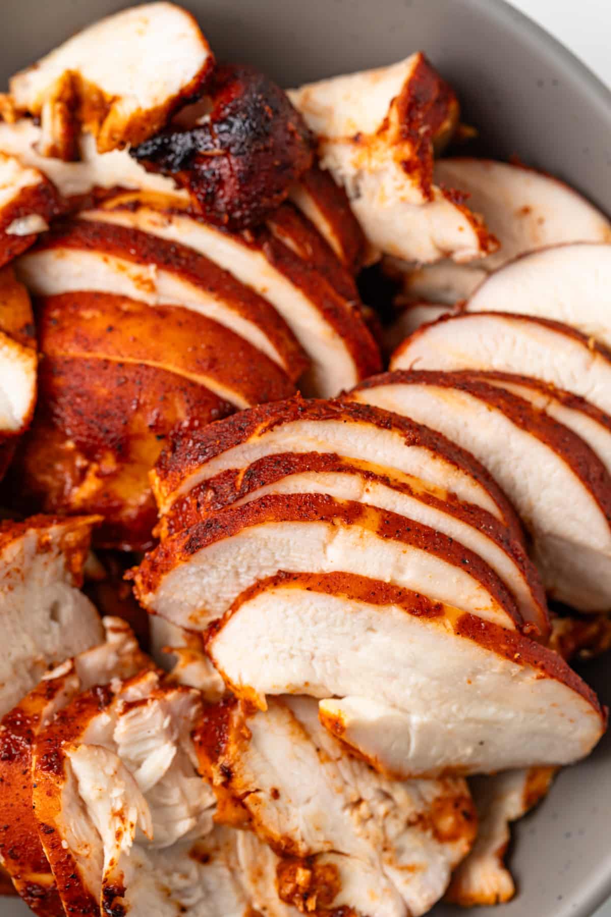 Close up of grilled chicken cooked in al pastor marinade.