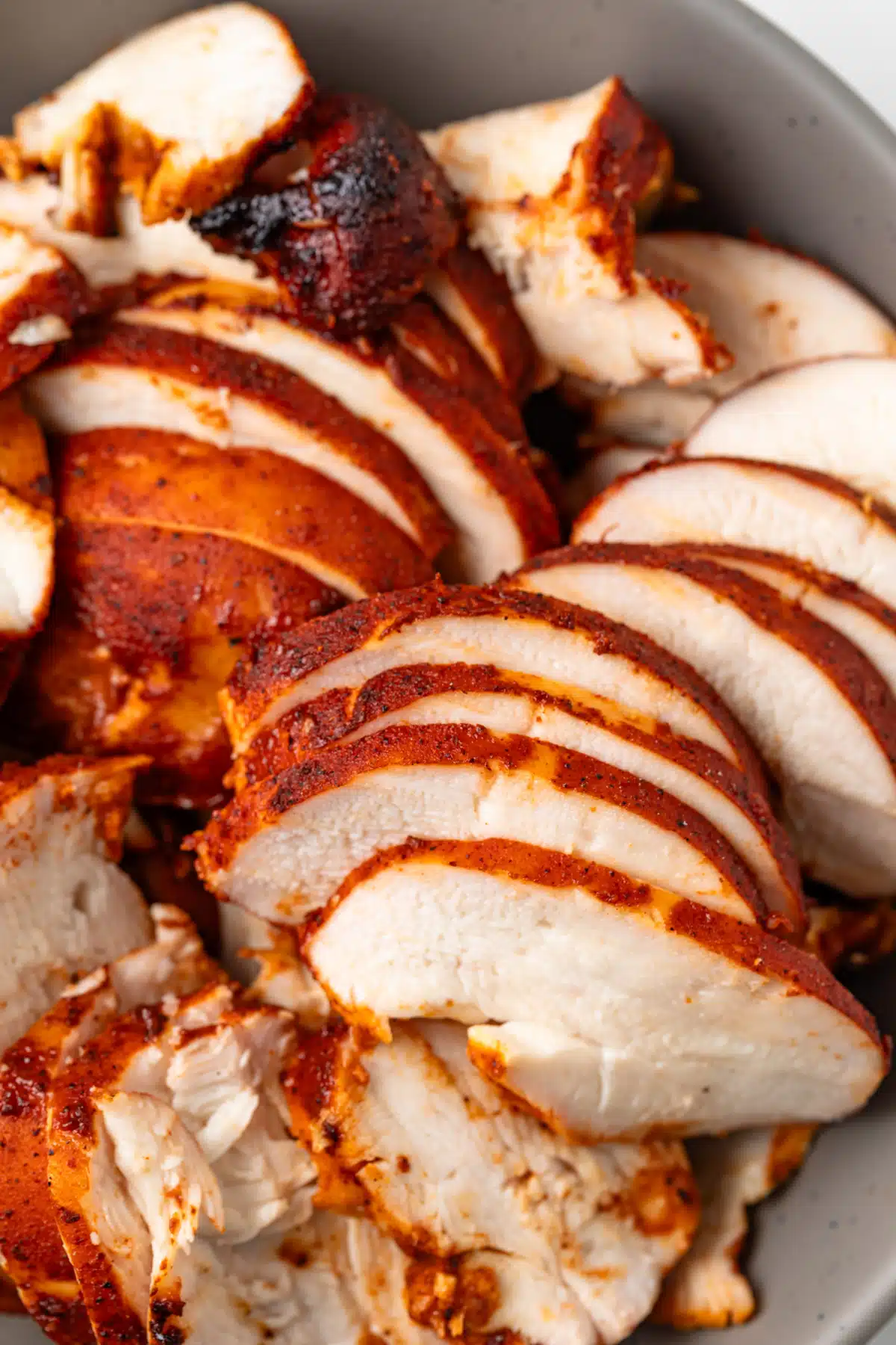 Close up of grilled chicken cooked in al pastor marinade.