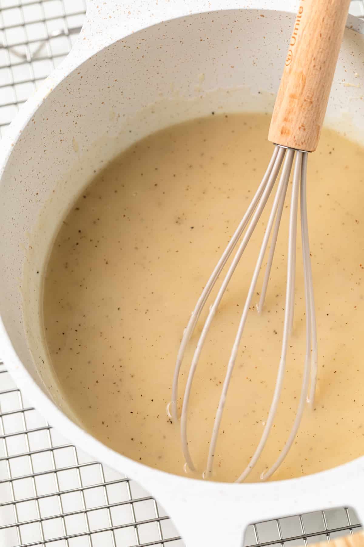 Chicken gravy in a saucepan.