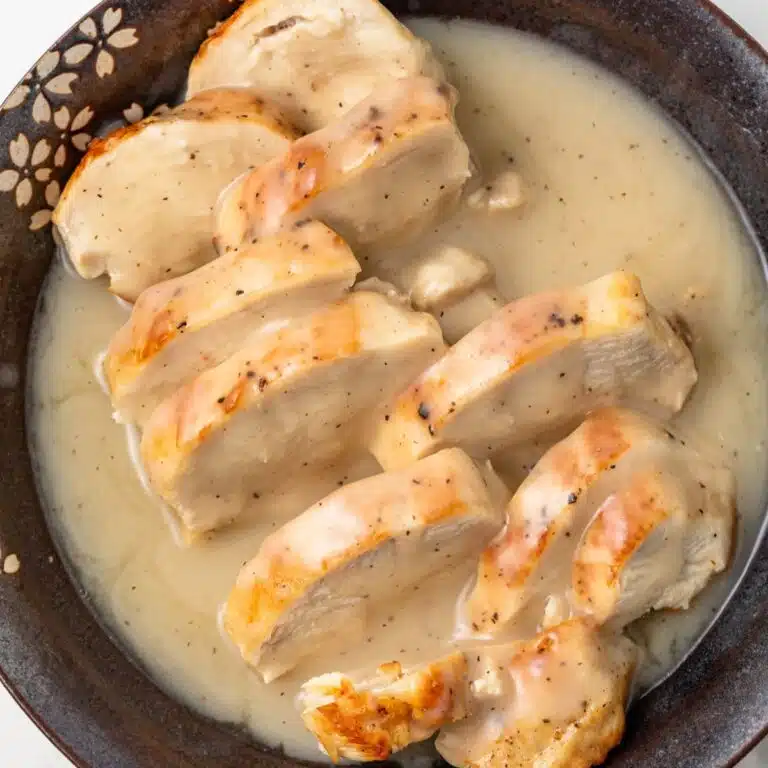 Chicken with chicken gravy in a bowl.