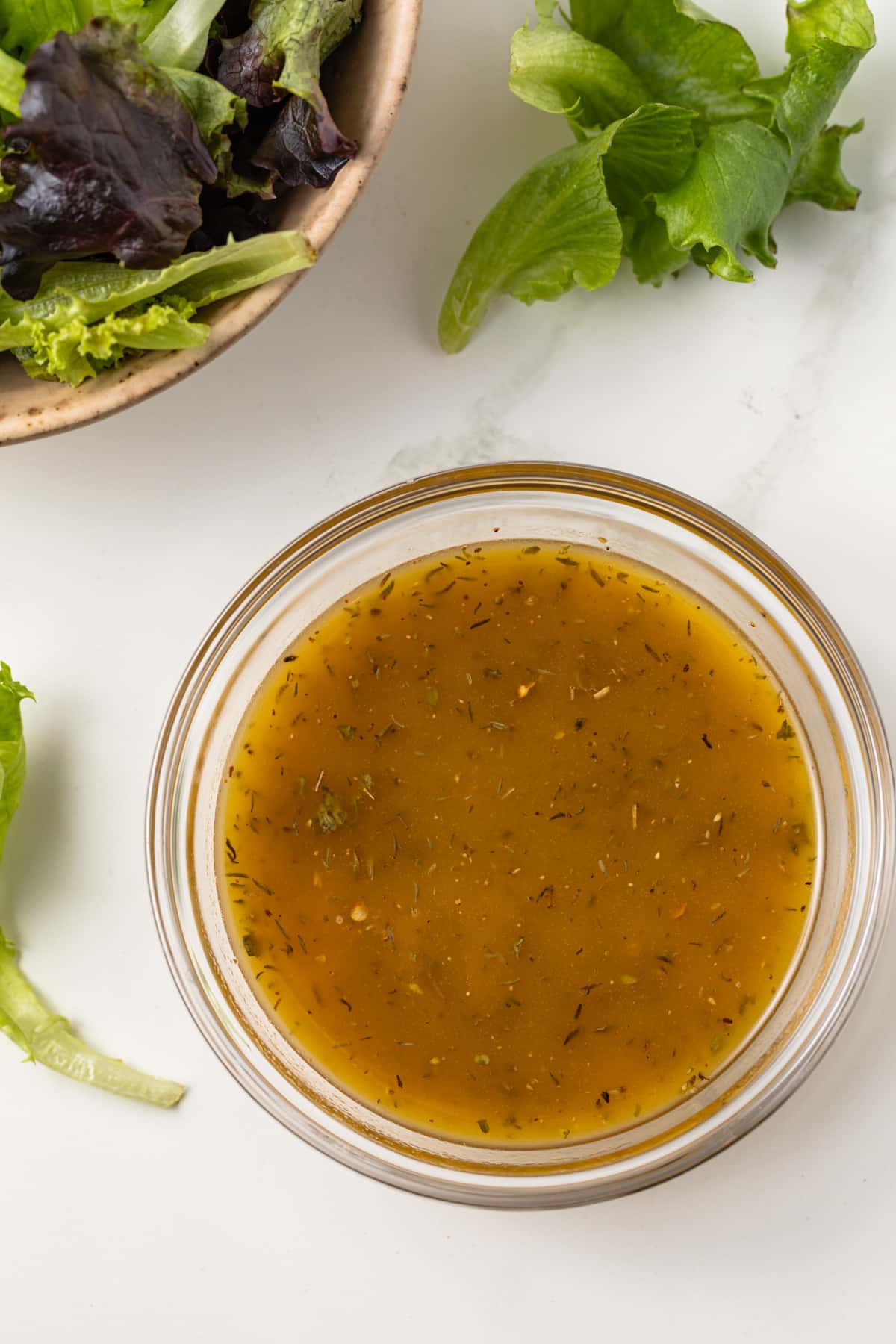 Homemade Italian dressing in a glass bowl.