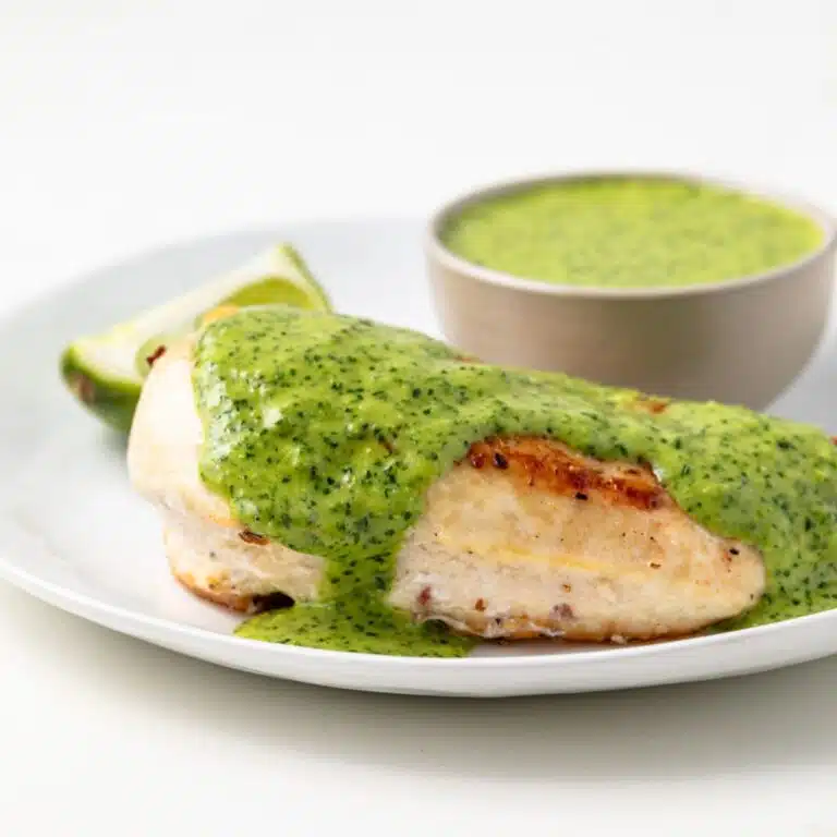 Mojo sauce spread over grilled chicken.
