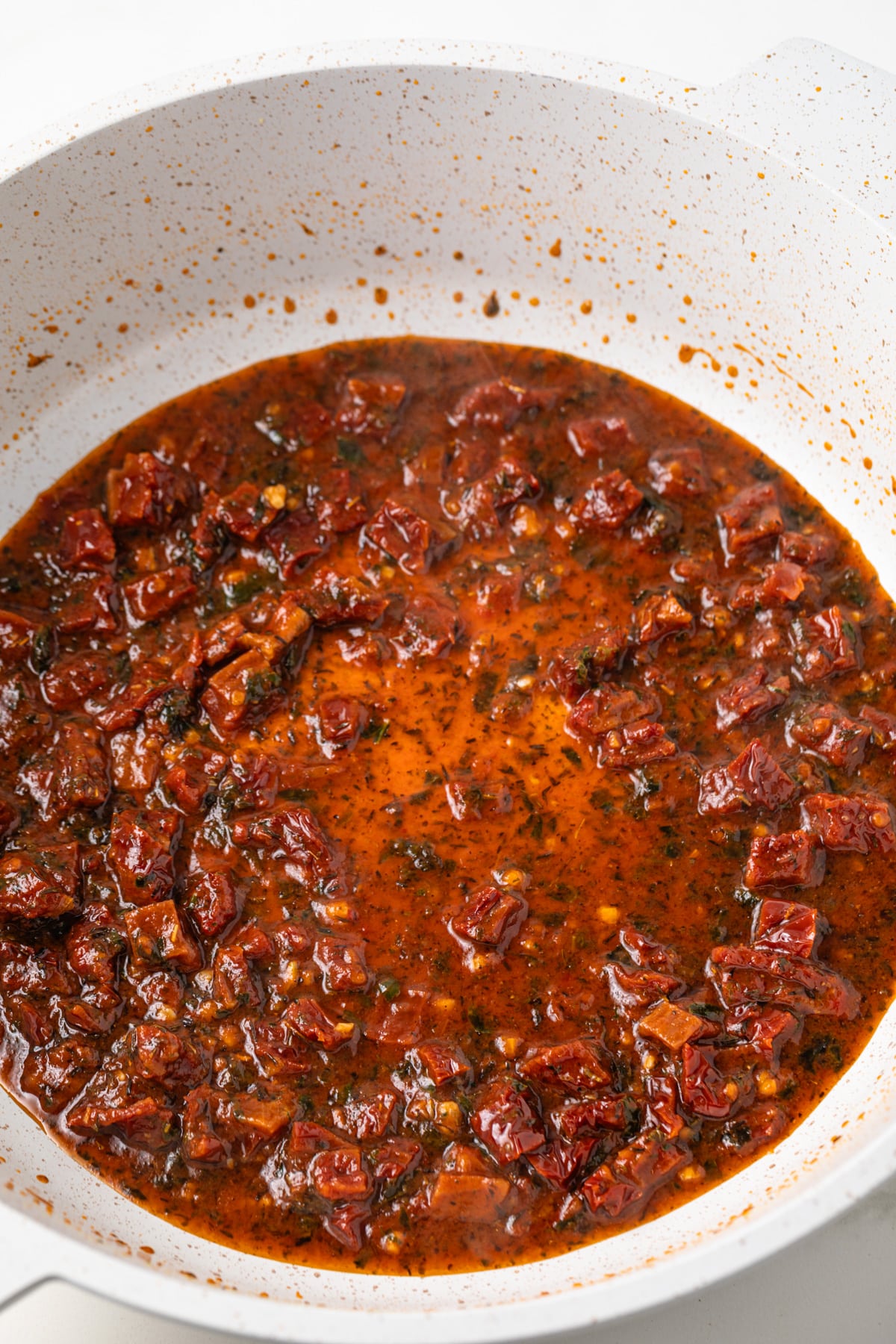 Base for sun dried tomato sauce in a pot.