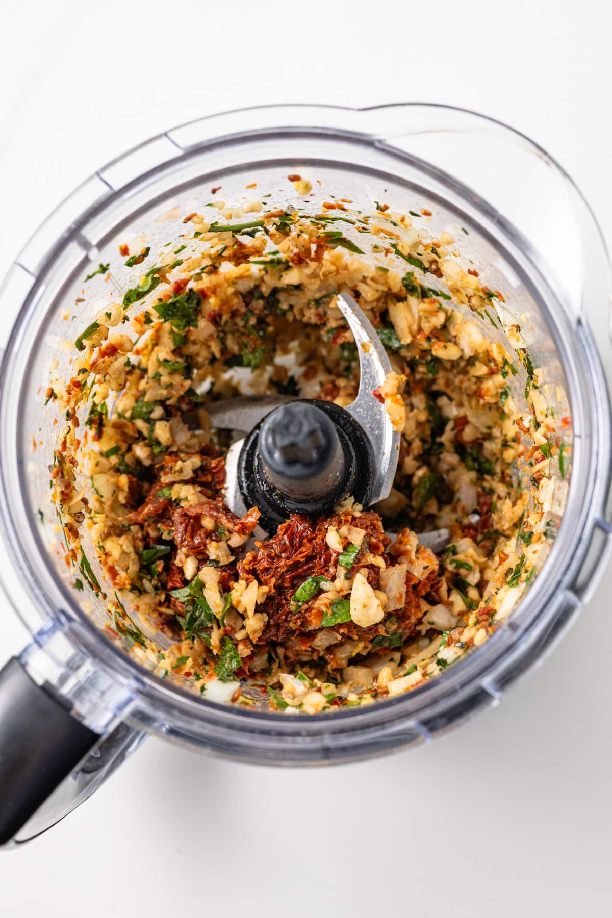 Tomatoes, pine nuts, onion, basil, parsley, and garlic chopped in a blender.