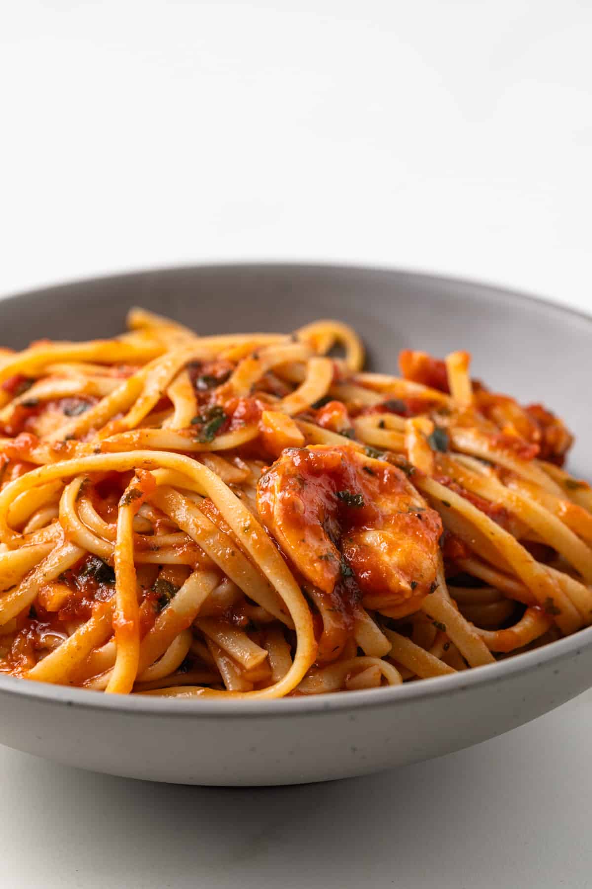 Fra Diavolo sauce with pasta and shrimp in a bowl.