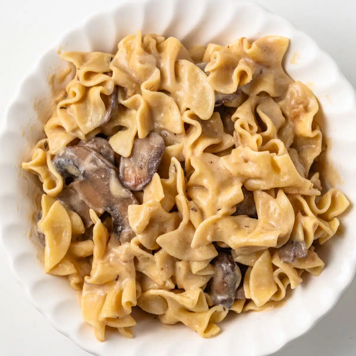 Mushroom stroganoff in a white bowl.