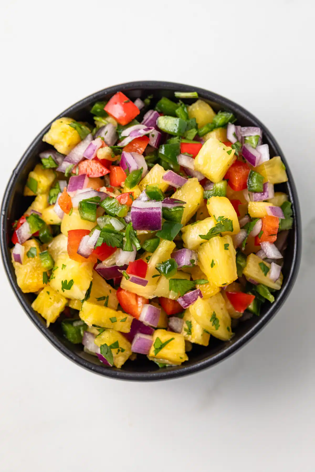 Overhead view of pineapple salsa in a bowl.