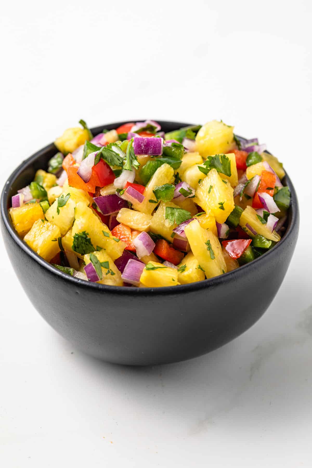 Side view of pineapple salsa in a bowl.