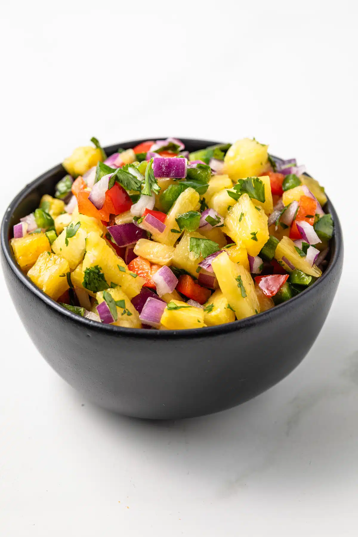 Side view of pineapple salsa in a bowl.