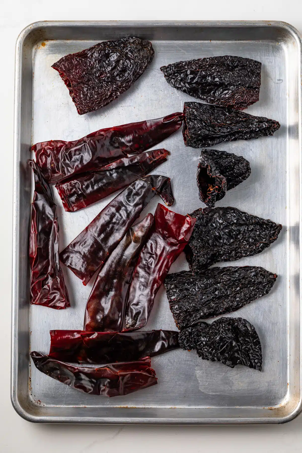 Dried chilis on a baking sheet.