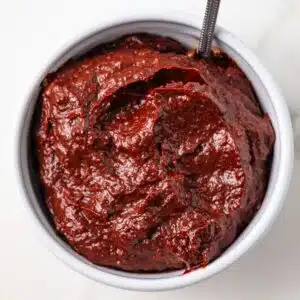 Overhead view of adobo sauce in white bowl.