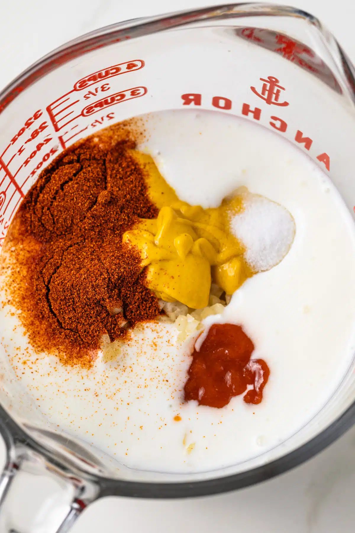 Ingredients combined in glass measuring cup.
