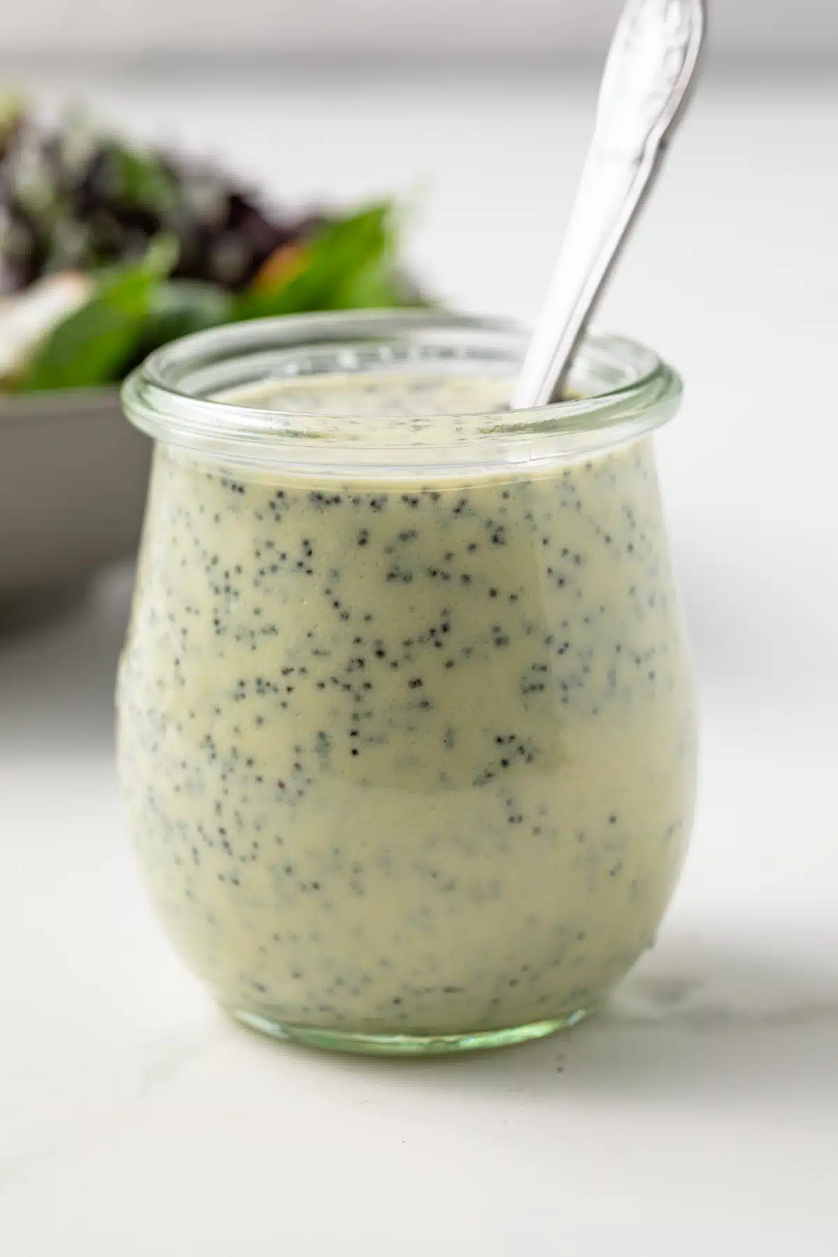 Jar of creamy poppy seed dressing.