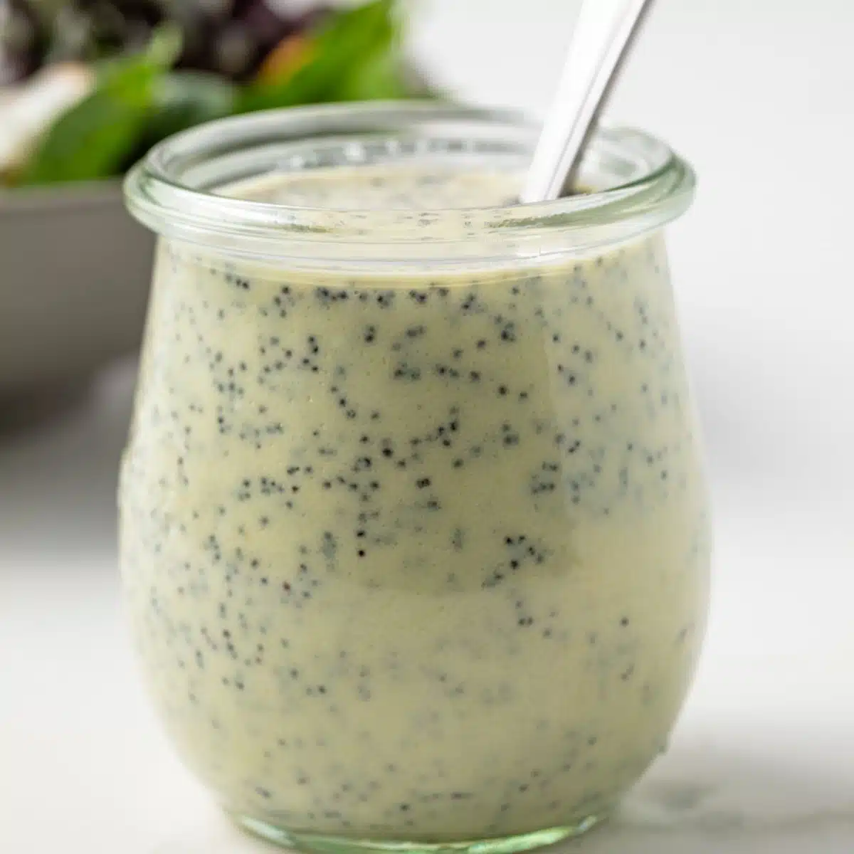 Jar of creamy poppy seed dressing.