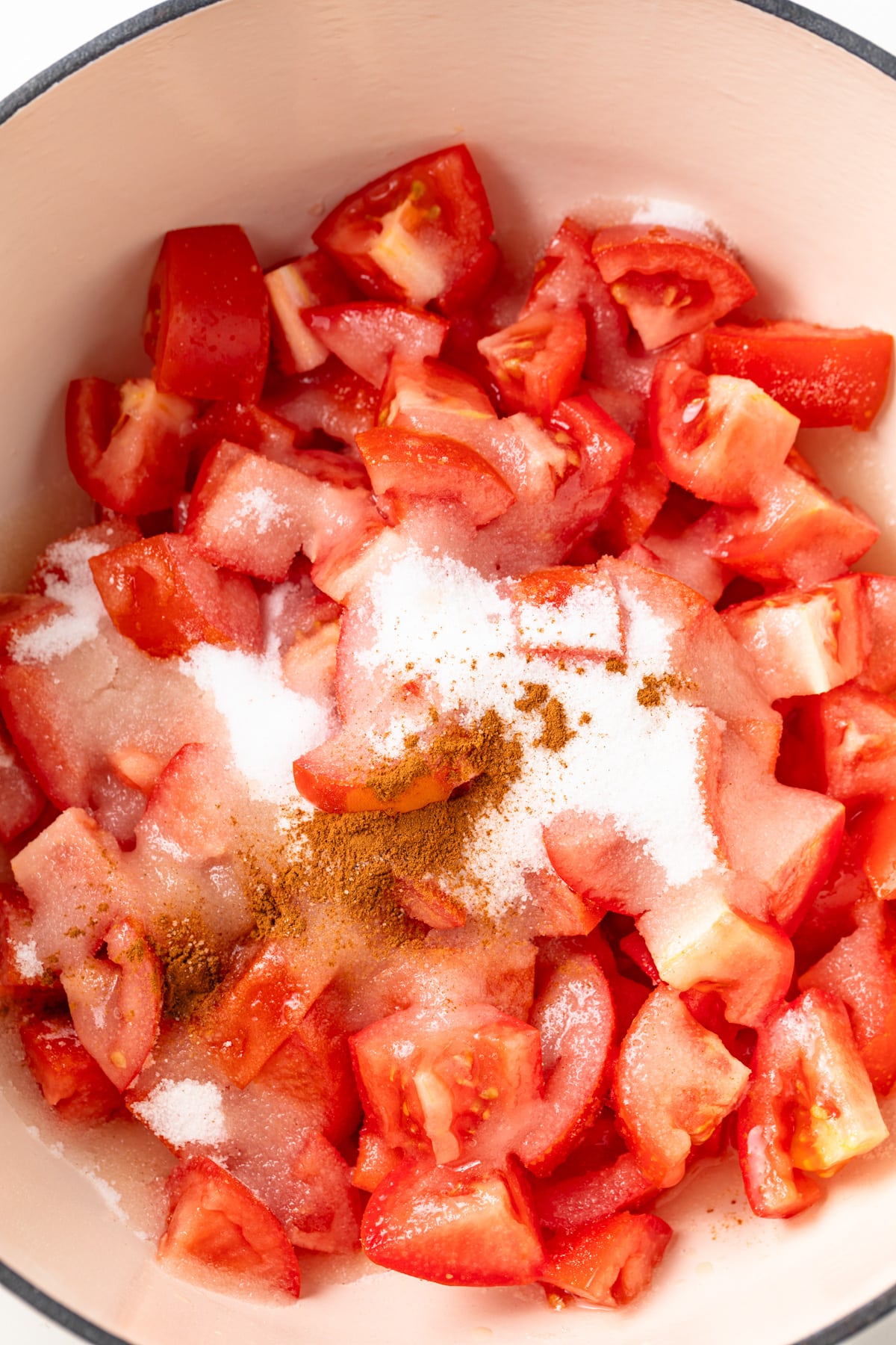 Ingredients for tomato jam in a pot.