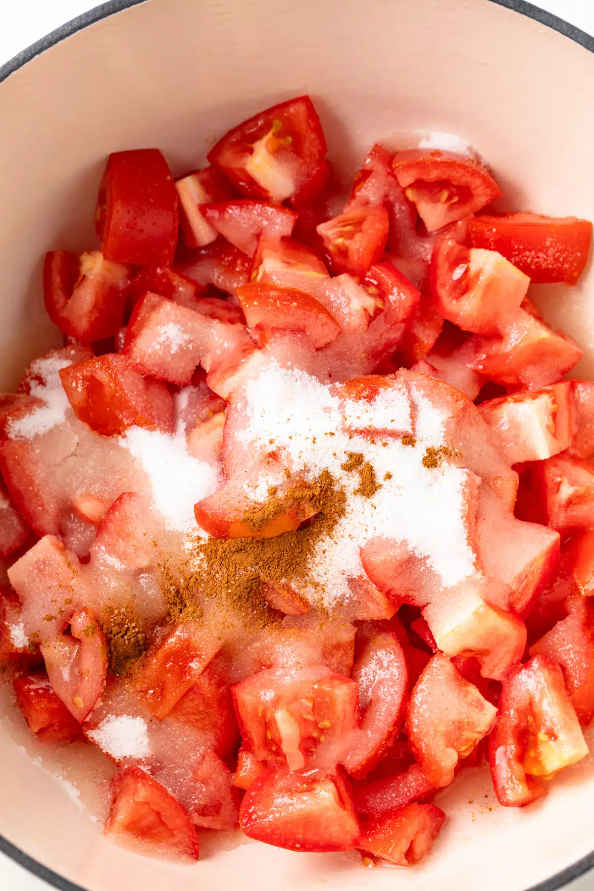 Ingredients for tomato jam in a pot.