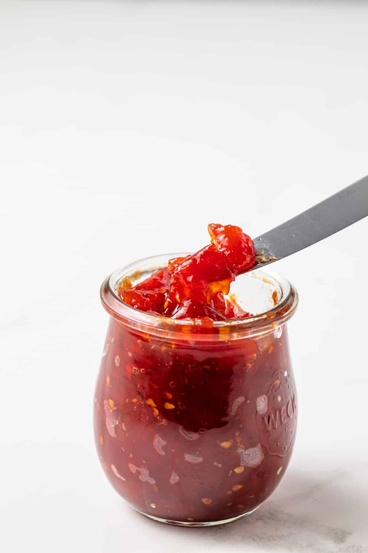 Roasted tomato jam in a glass jar.