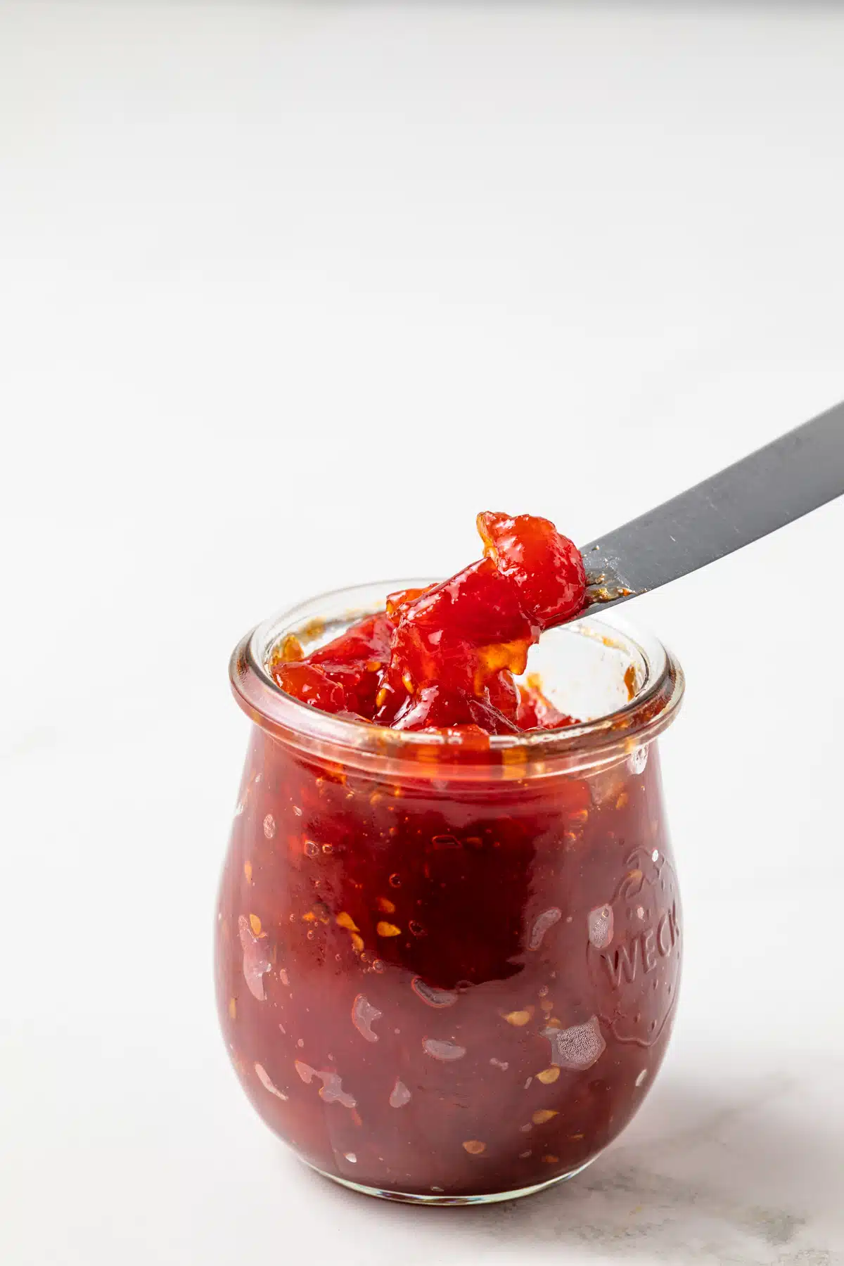 Roasted tomato jam in a glass jar.