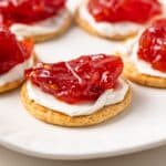 Side view of roasted tomato jam on top of crackers.