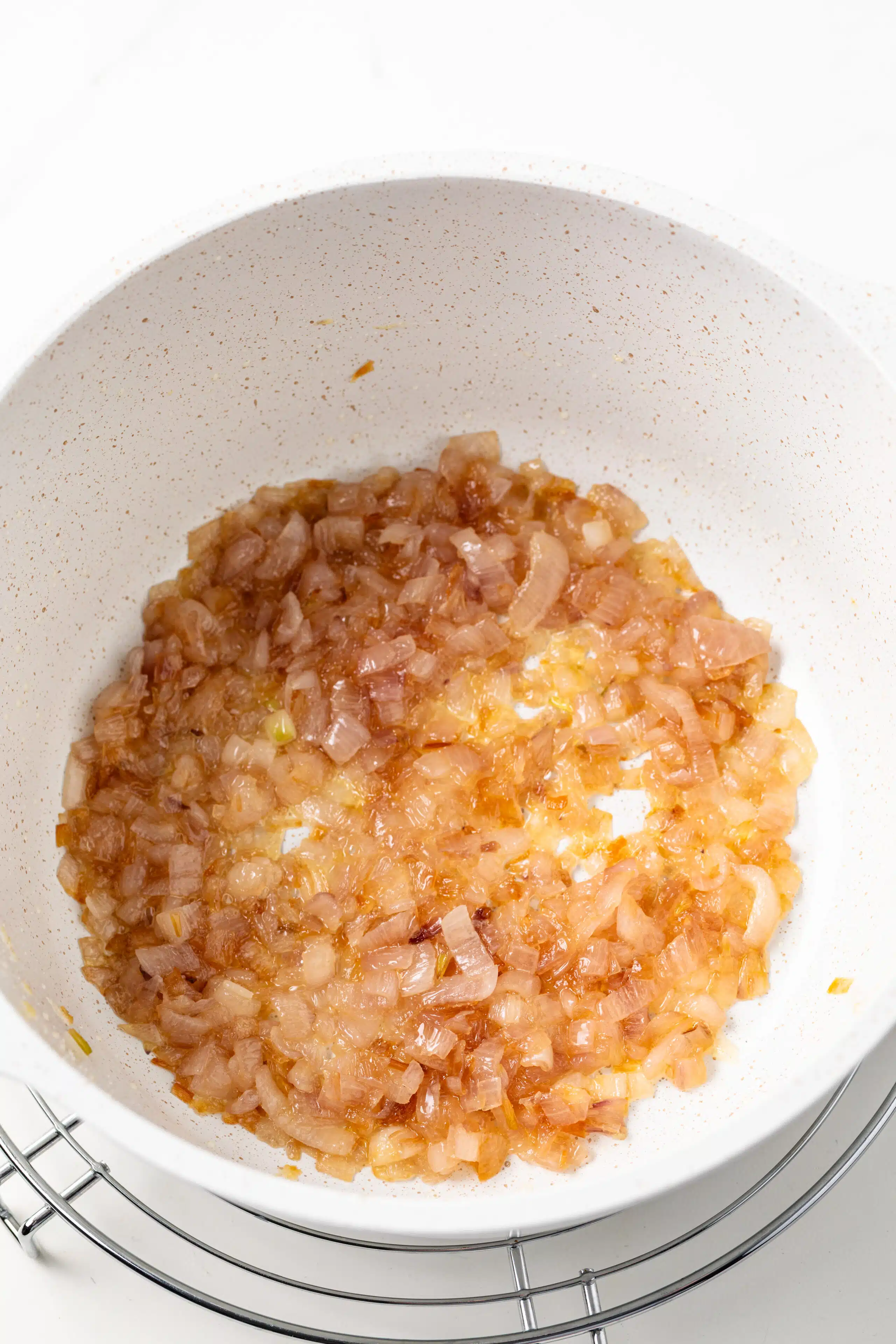 Shallots cooked with butter in saucepan.