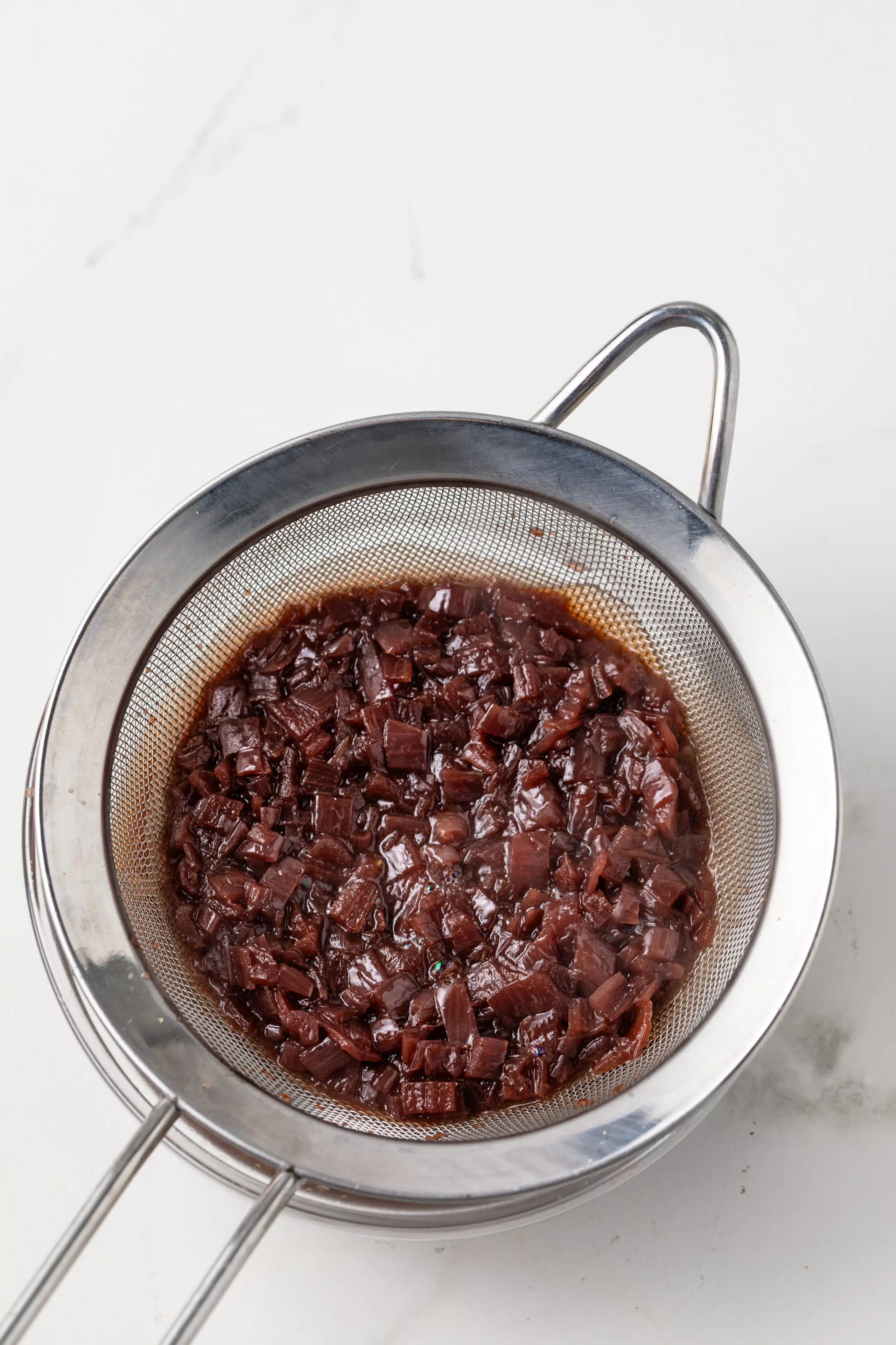 Separating liquids from solids in sieve.