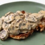 Side view of Dijon Mushroom Sauce over fried pork chop.
