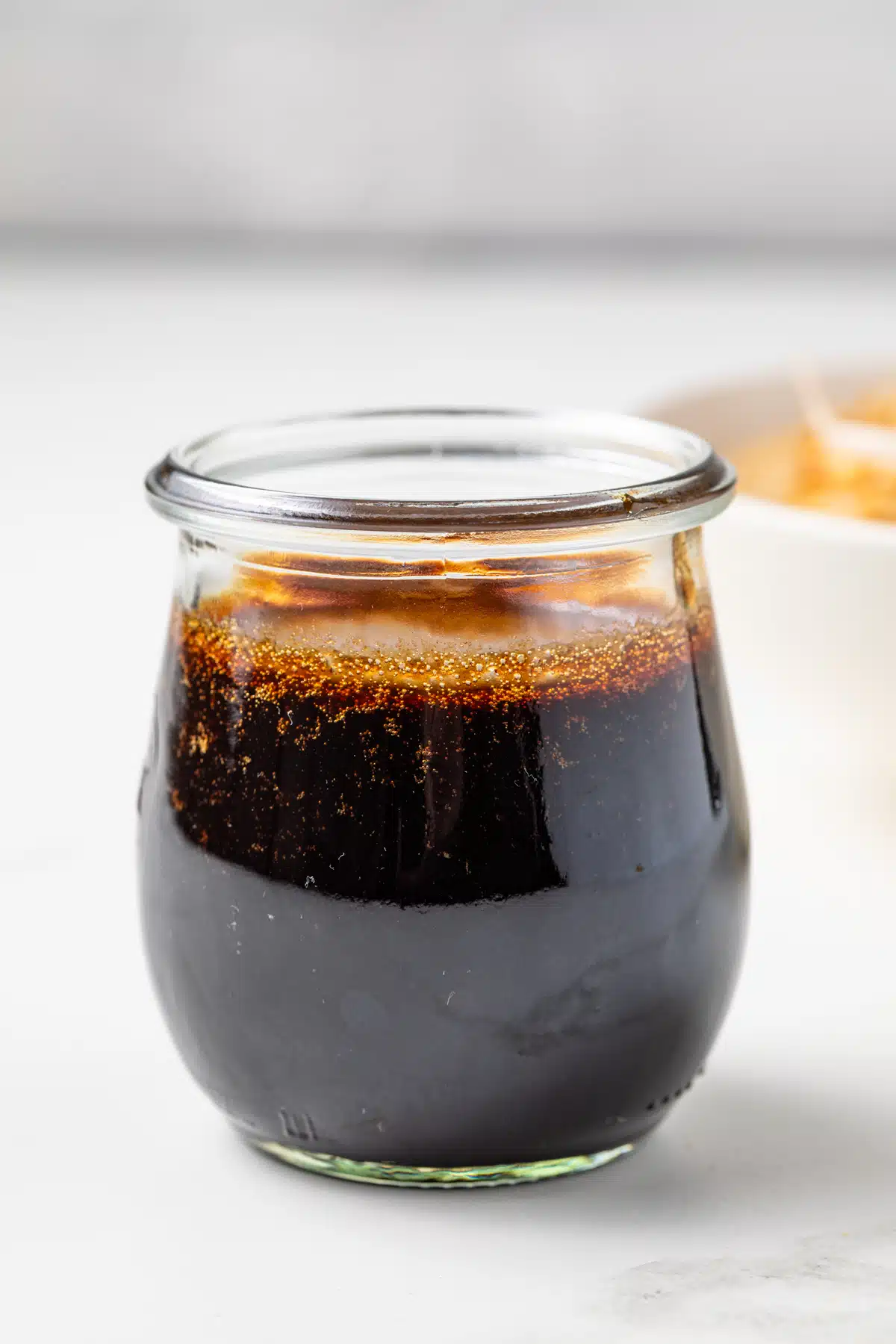 Side view of Pad Thai sauce in a glass jar.