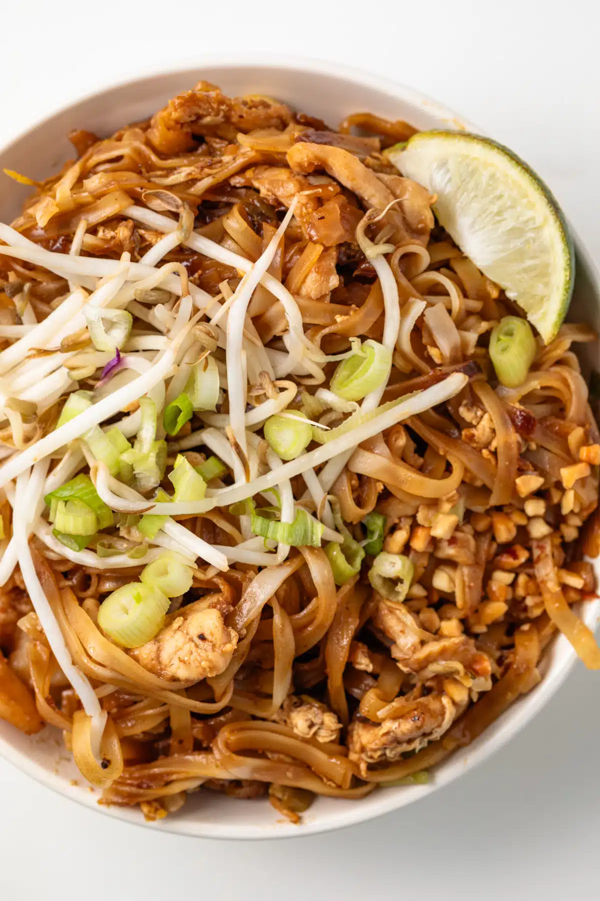 Close up of Pad Thai in a white bowl.