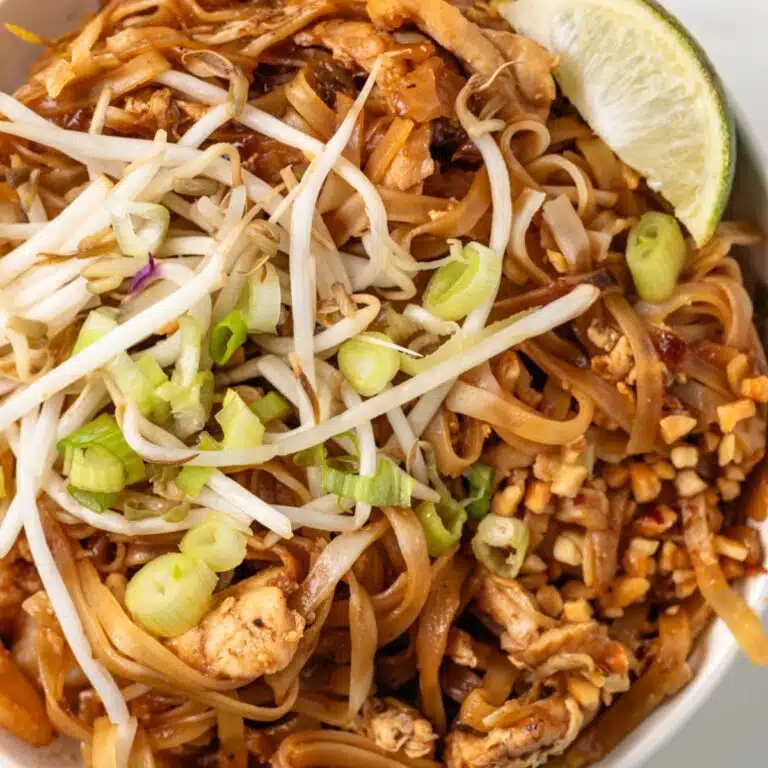 Close up of Pad Thai in a white bowl.