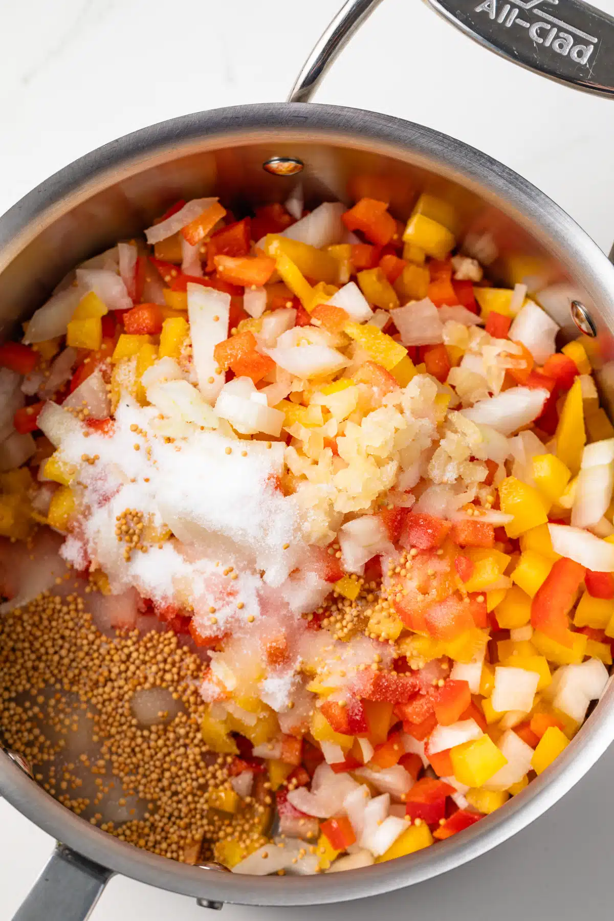 Ingredients for sweet pepper relish in saucepan.