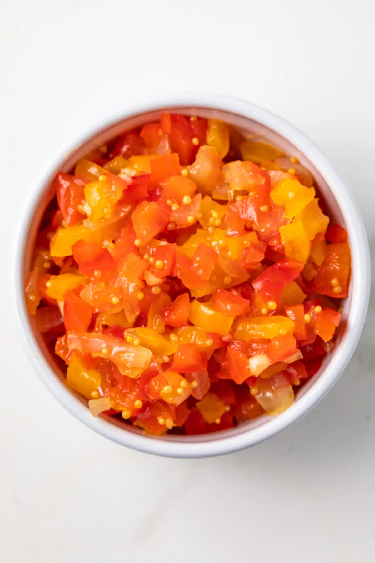 Sweet pepper relish in white bowl.
