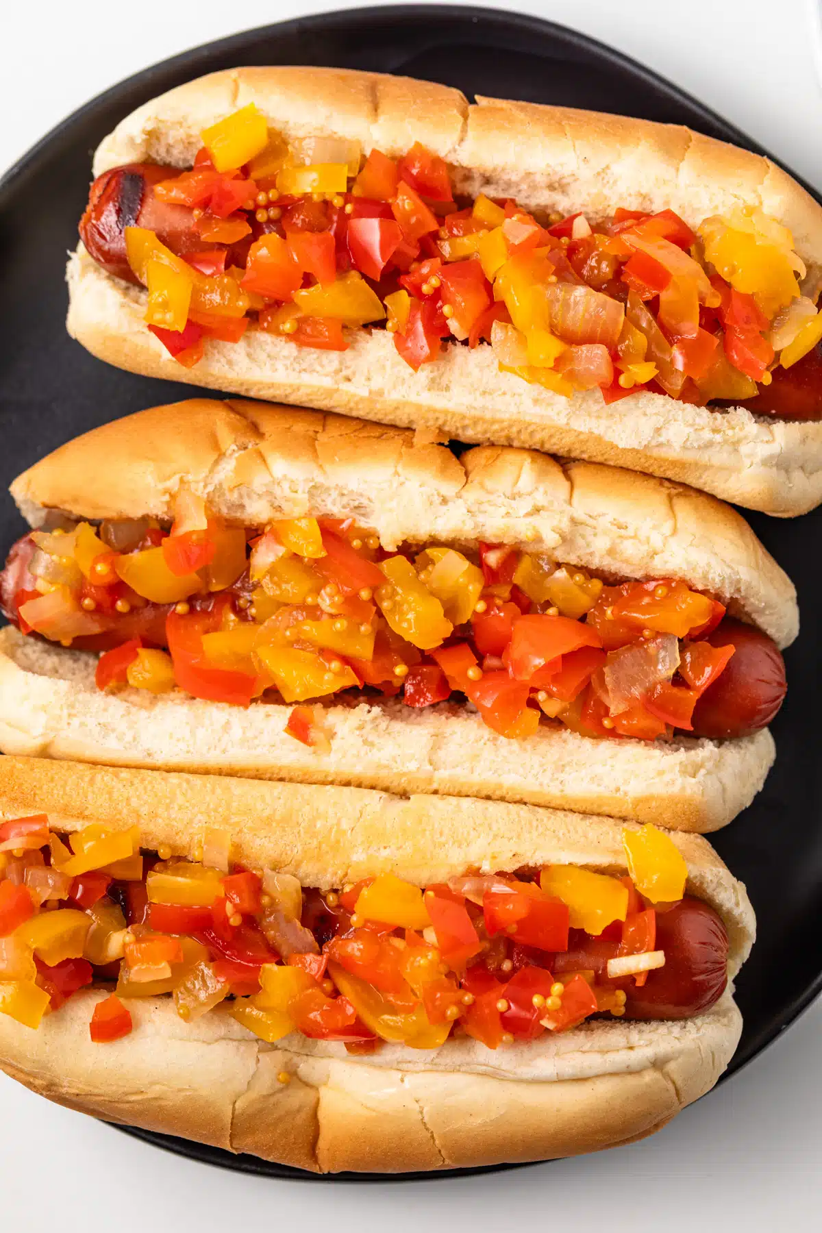 Close up of sweet pepper relish over hotdogs.