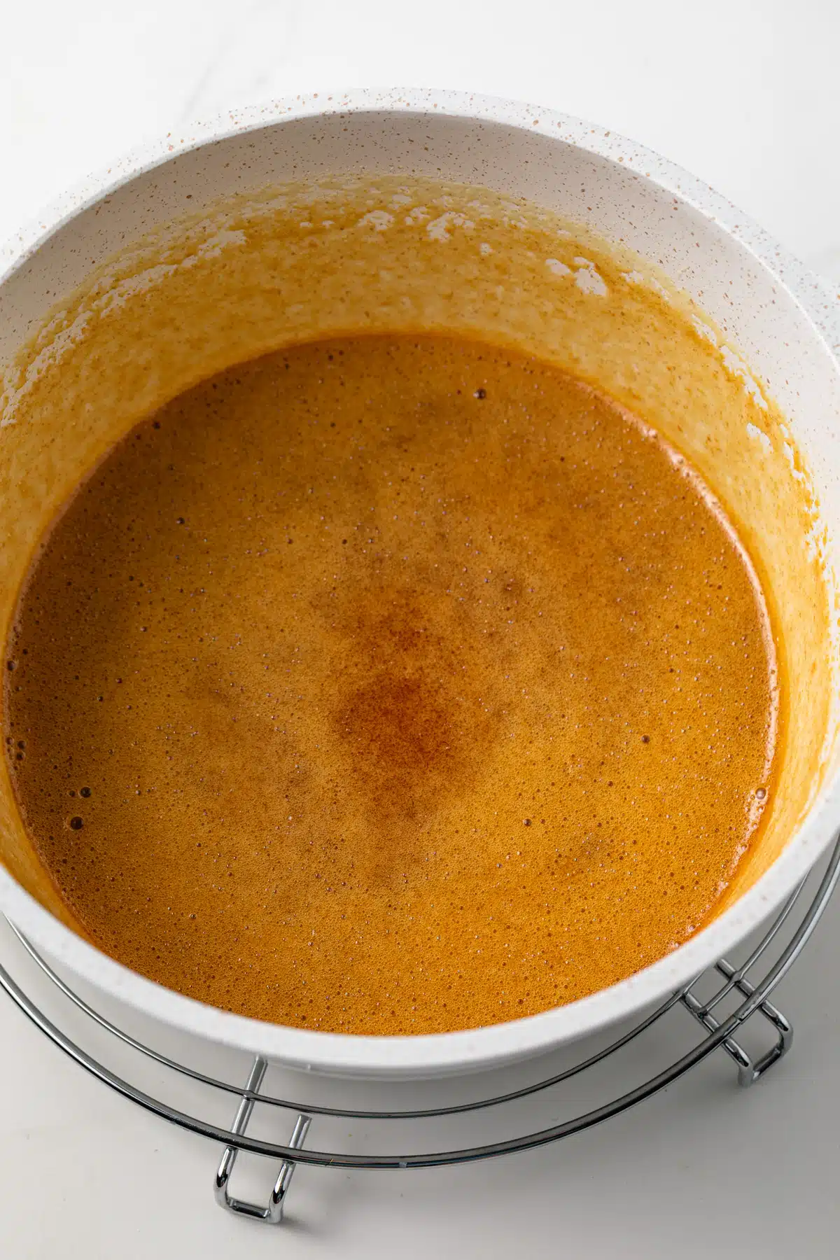 Cooking ingredients until caramel in color.