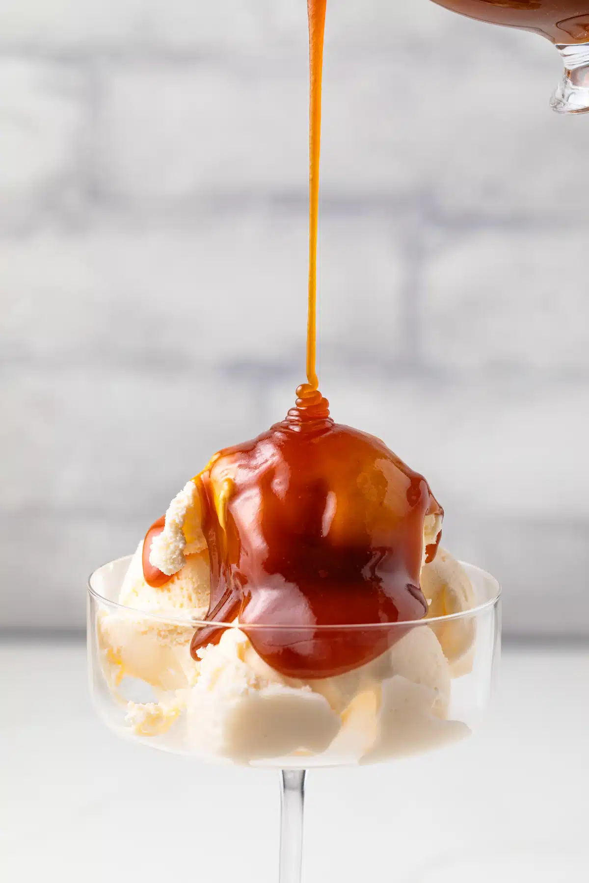 Drizzling buttermilk caramel sauce over ice cream.