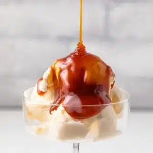 Drizzling buttermilk caramel sauce over ice cream.