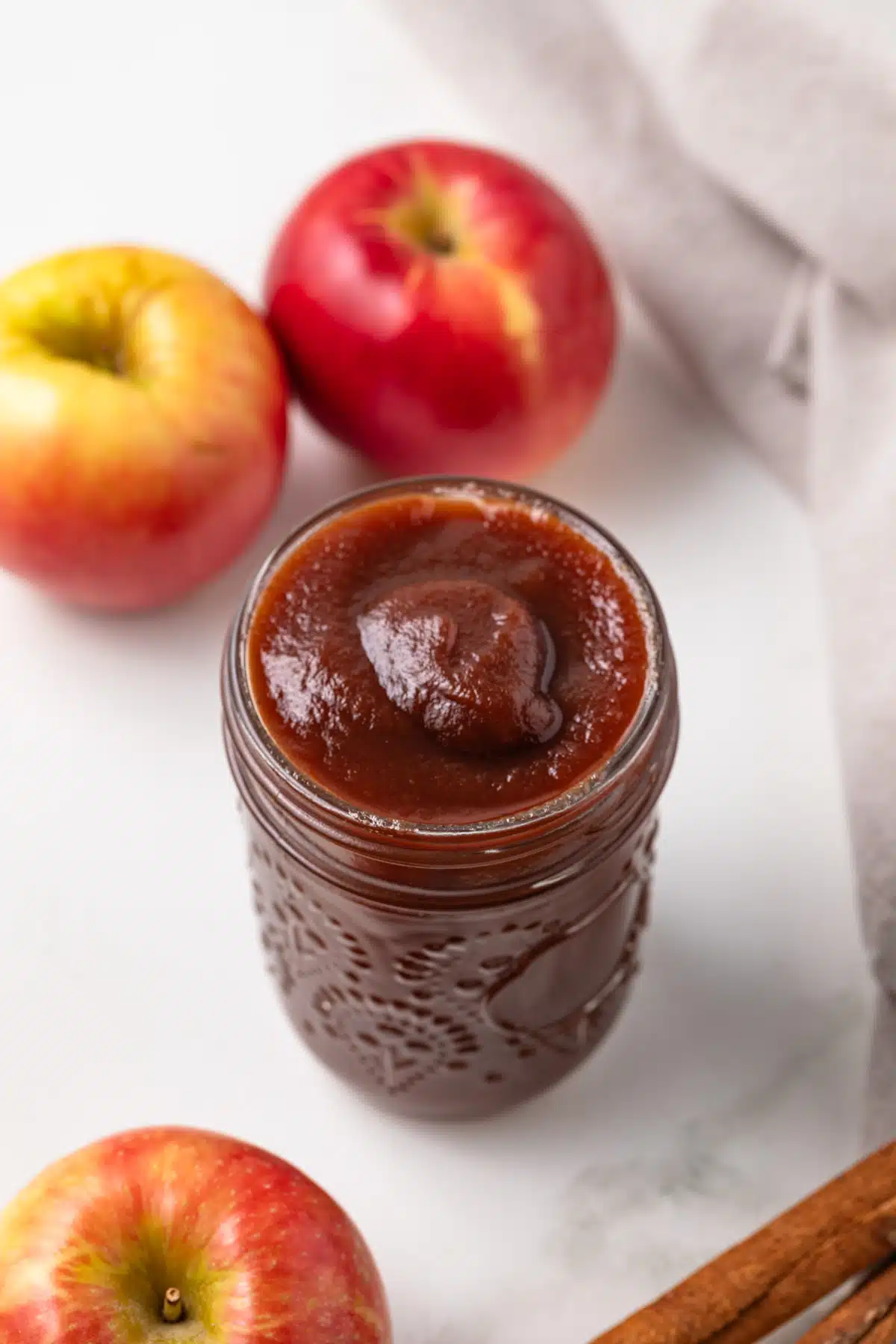 High angled view of slow cooker apple butter in a jar.