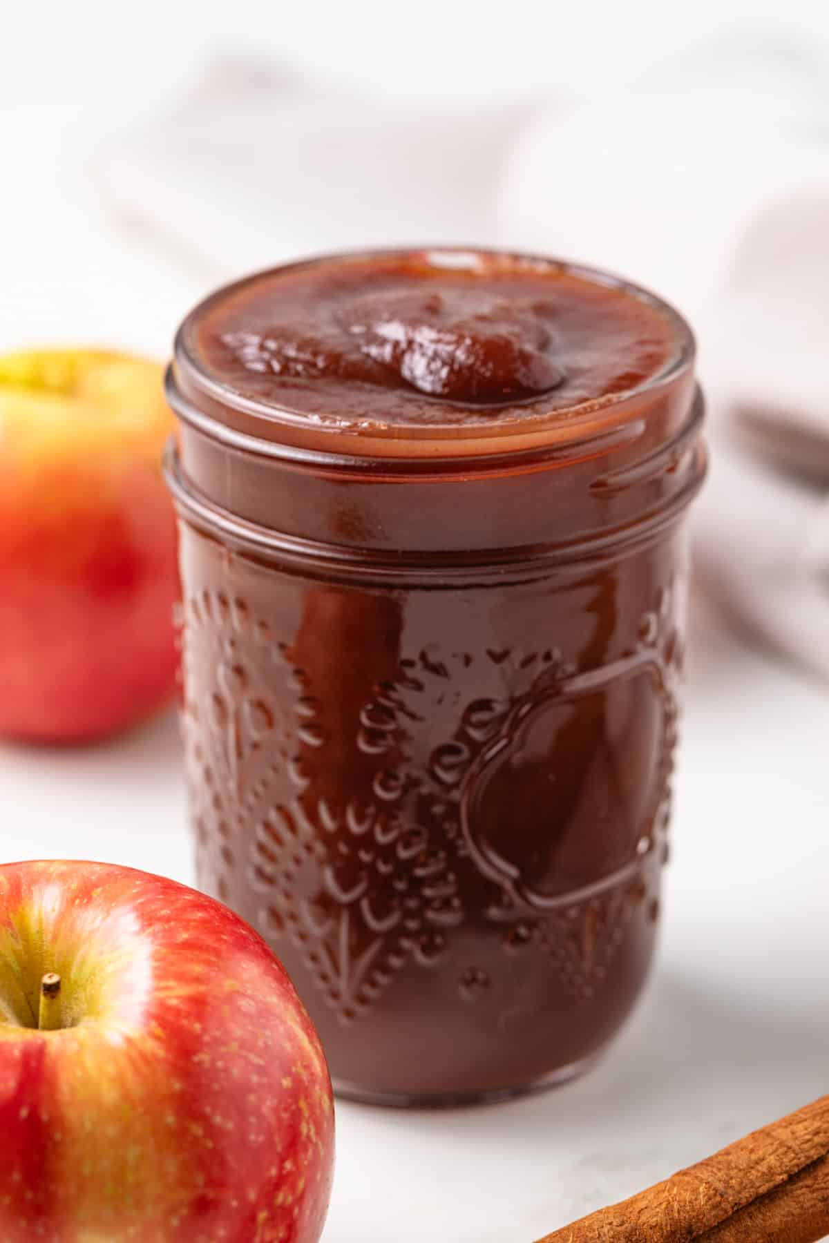 Side view of apple butter in a jar.