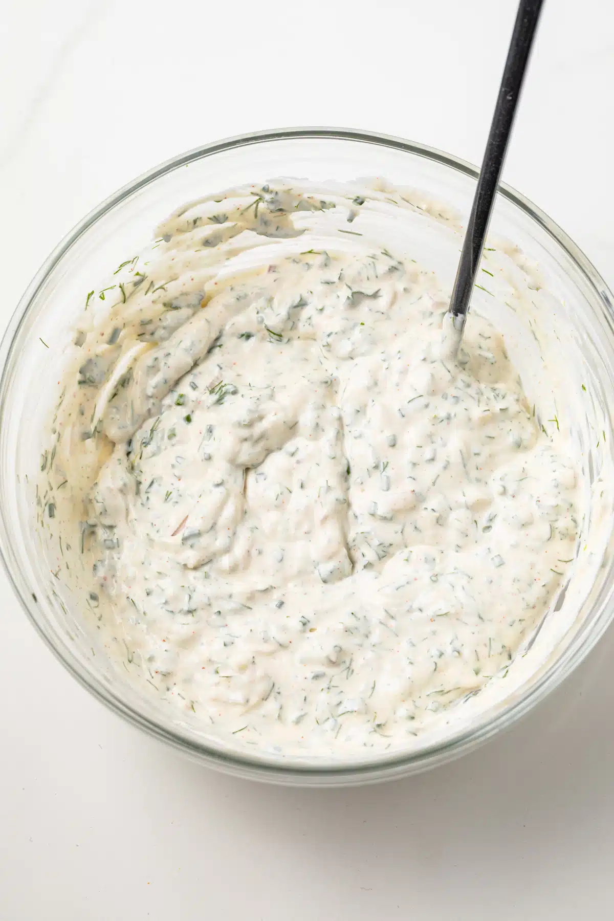 Creamy herb sauce in a bowl.