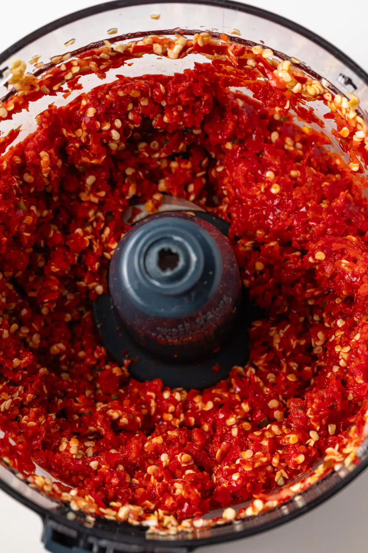 Ground peppers in a food processor.
