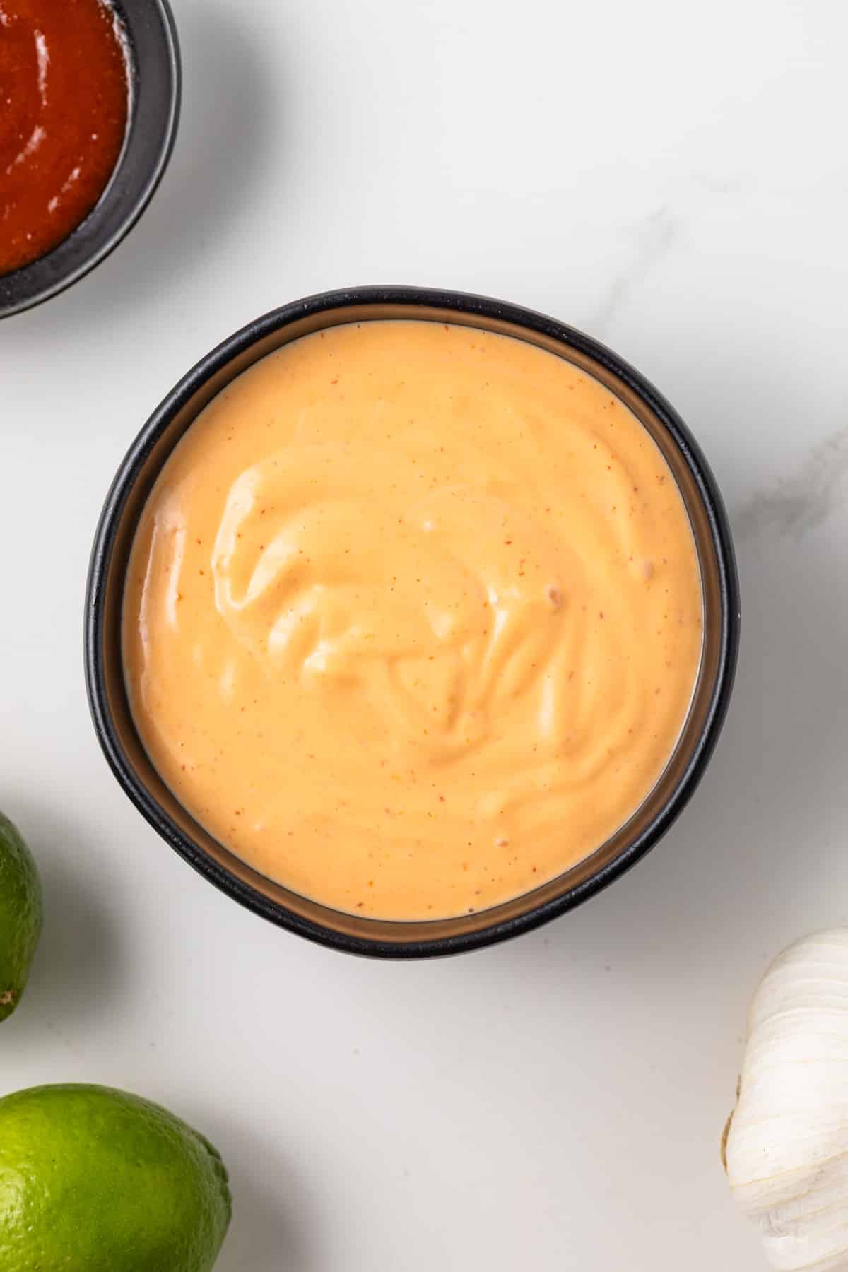 Overhead view of sriracha aioli in a bowl.