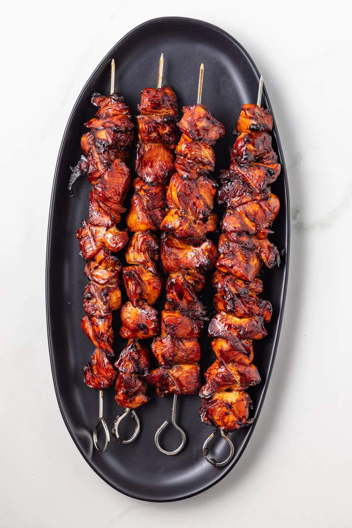 Yakitori sauce marinated chicken on skewers.