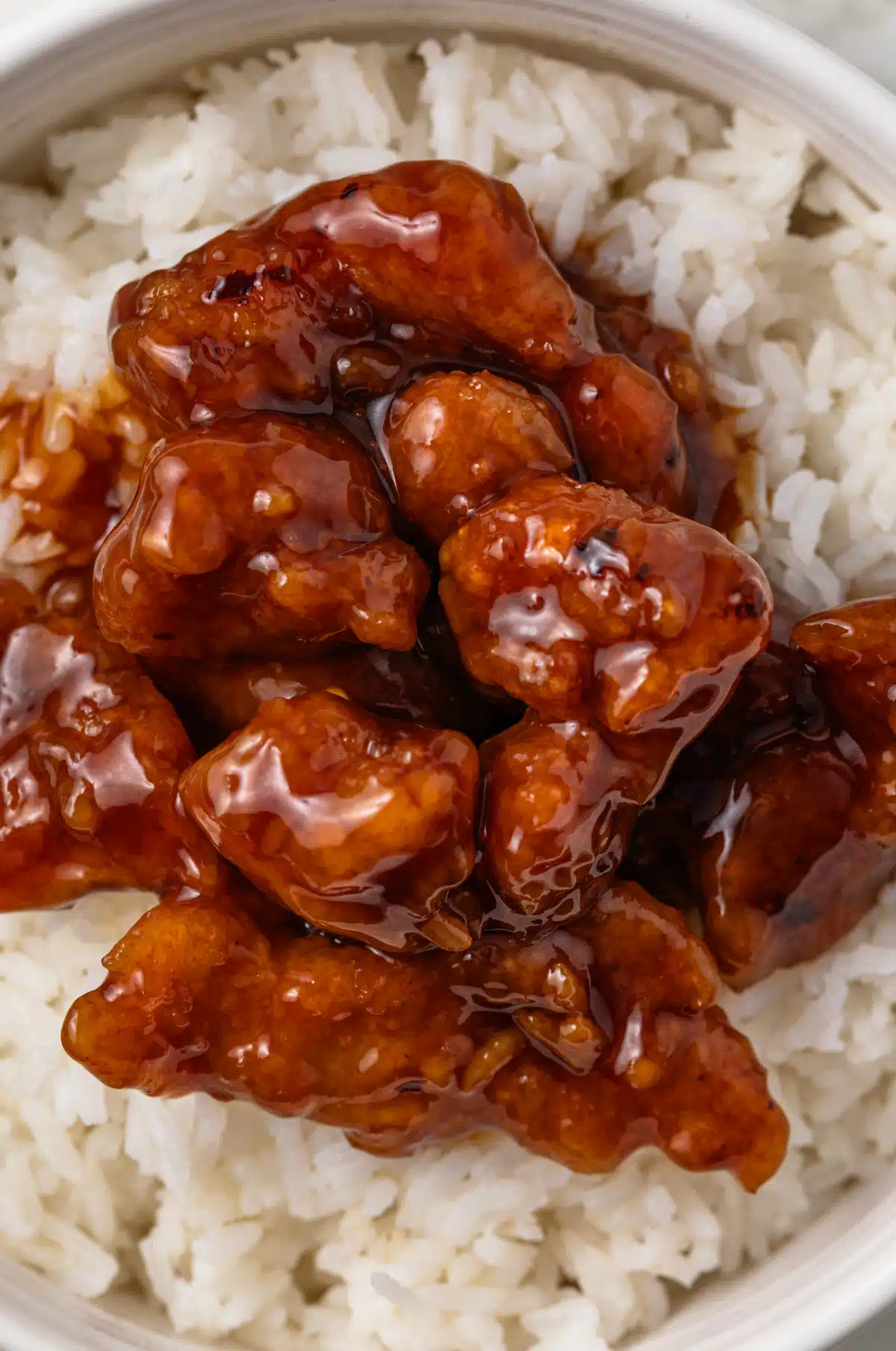 Chicken coated in general tso sauce.